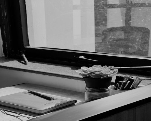 organized work desk with water and natural light
